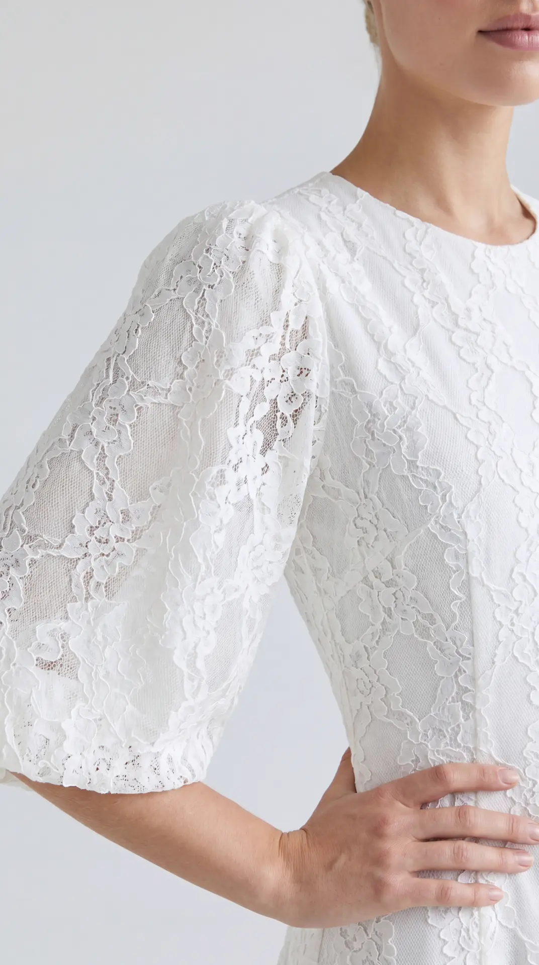 Visual merchandising guide cover — close-up fabric detail of a white floral lace dress sleeve, the texture level a boutique display should communicate